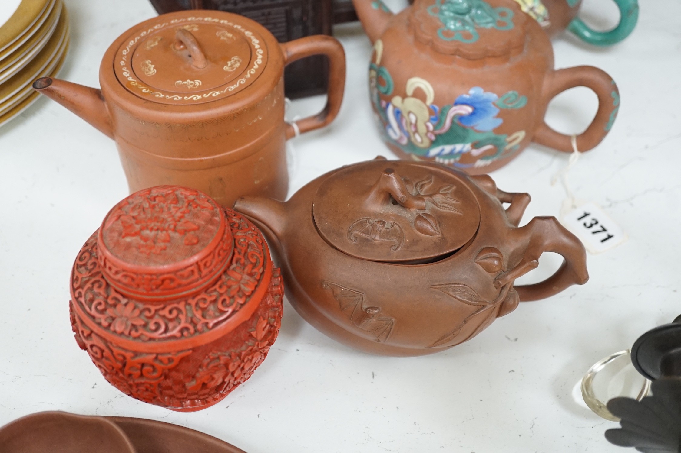 A quantity of Chinese Yixing teapots, a cinnabar resin jar and cover, a Samson teapot etc.